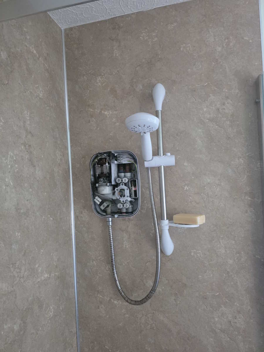 Shower enclosure and fittings during repair work in a Carlisle bathroom.